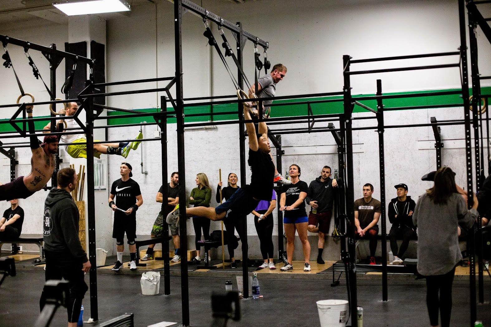 Experienced athletes on the rig — toes-to-bar and ring work during a Functional Fitness class