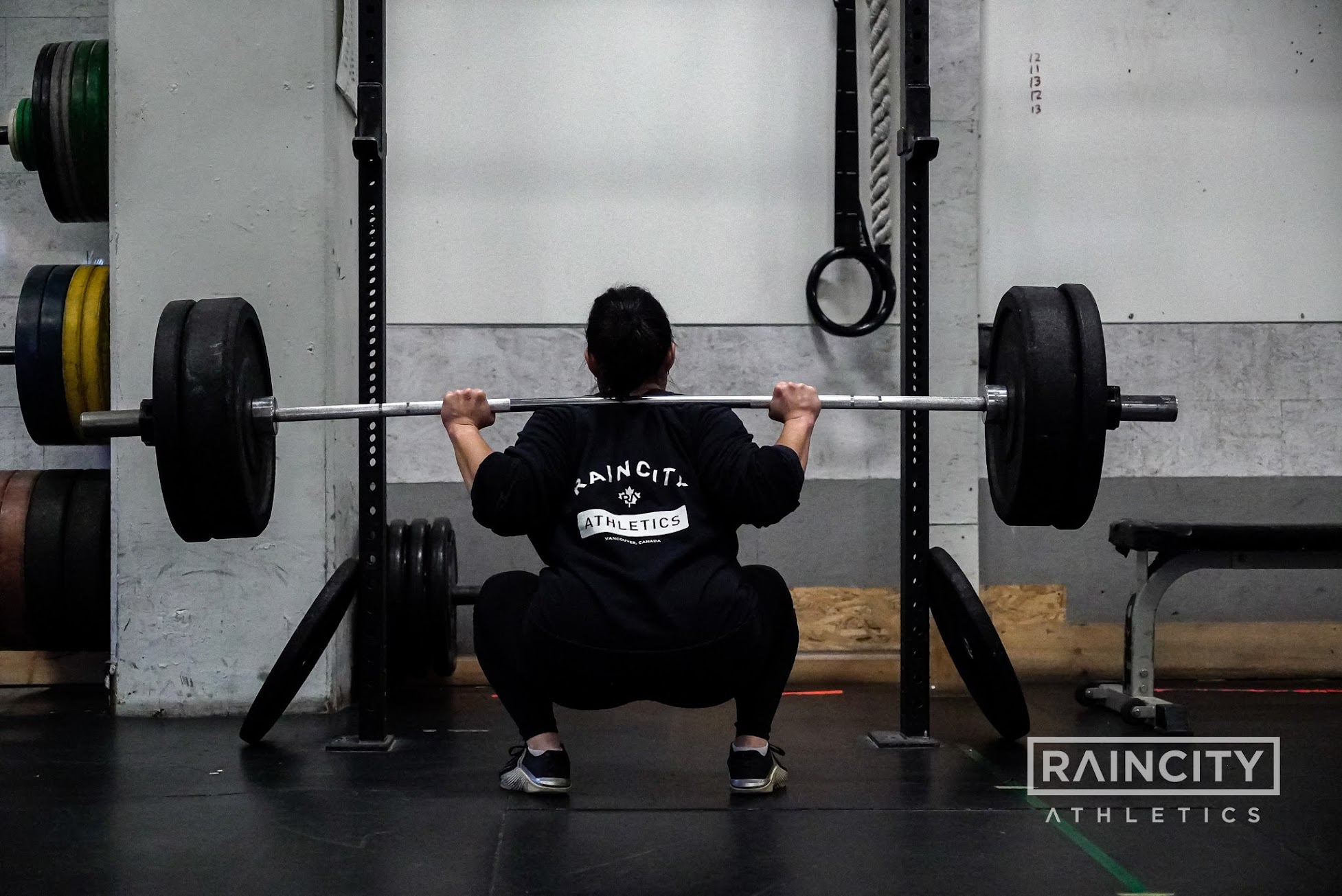 Athletes building barbell strength in class