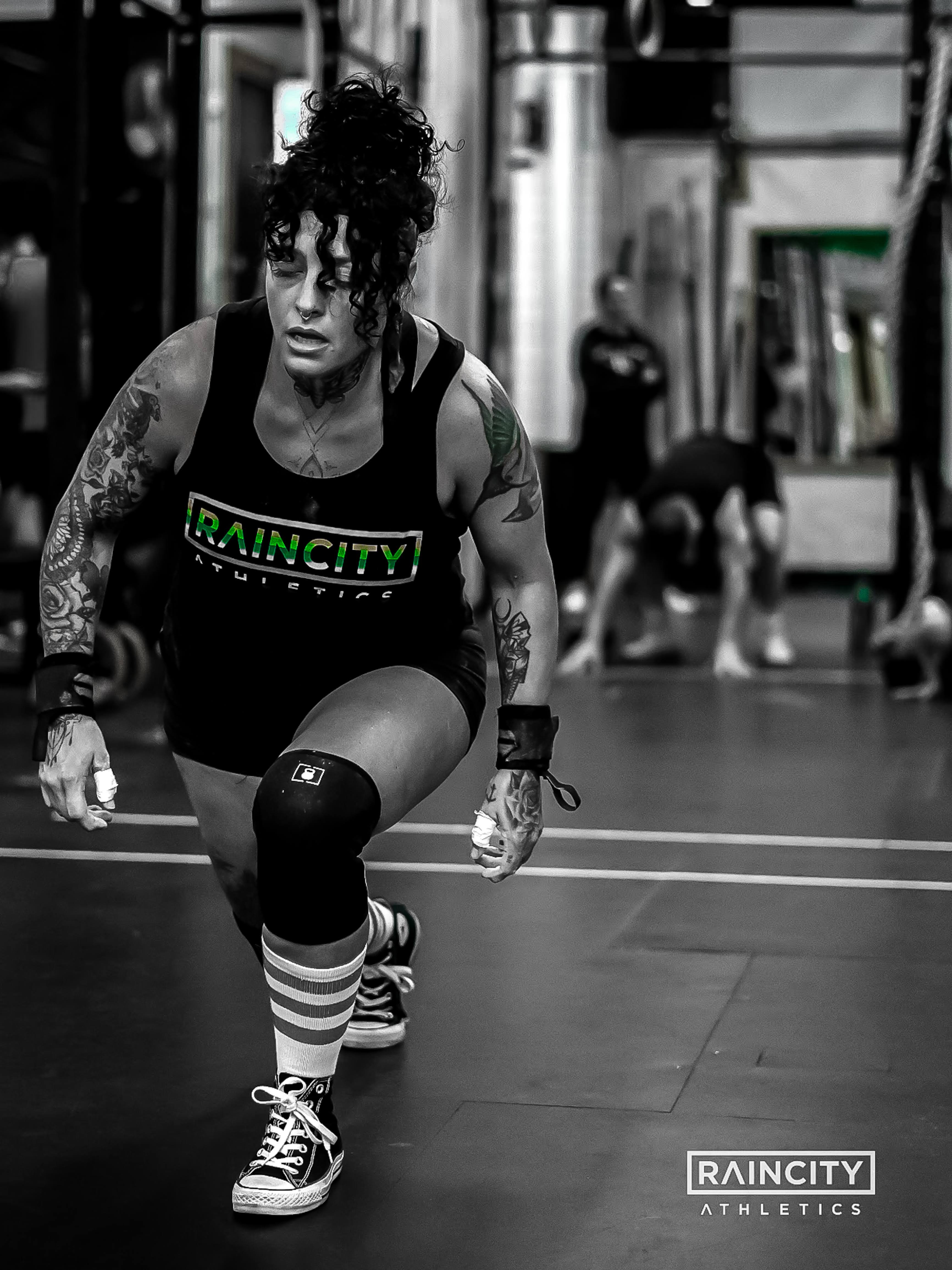 An athlete driving through a heavy lunge in class