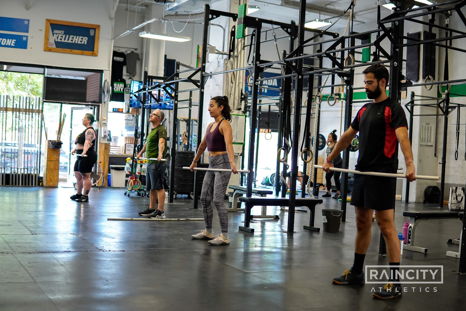 An athlete receiving a barbell snatch overhead