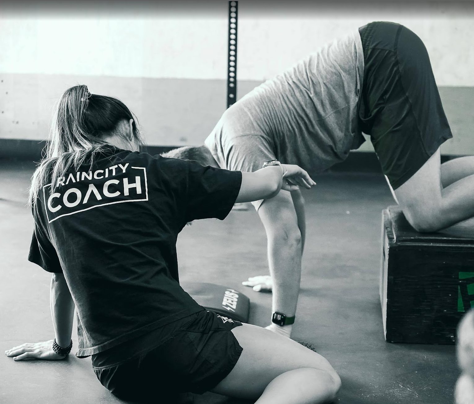 A coach working one-on-one with a new athlete during On-Ramp