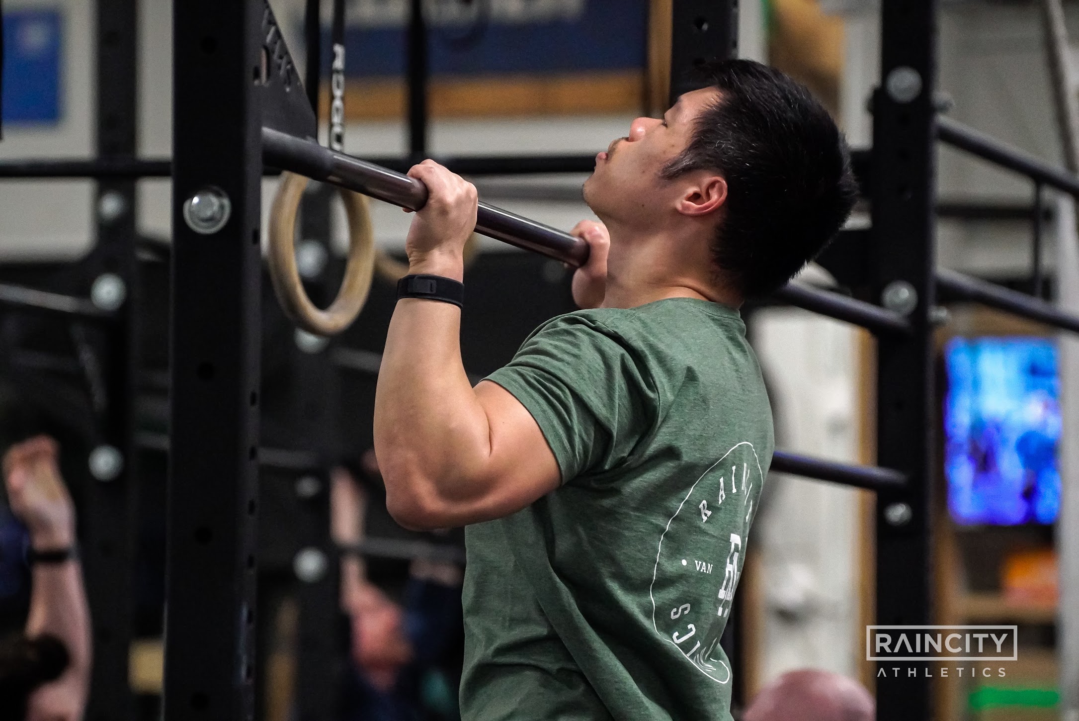 An athlete moving through a barbell lift in class