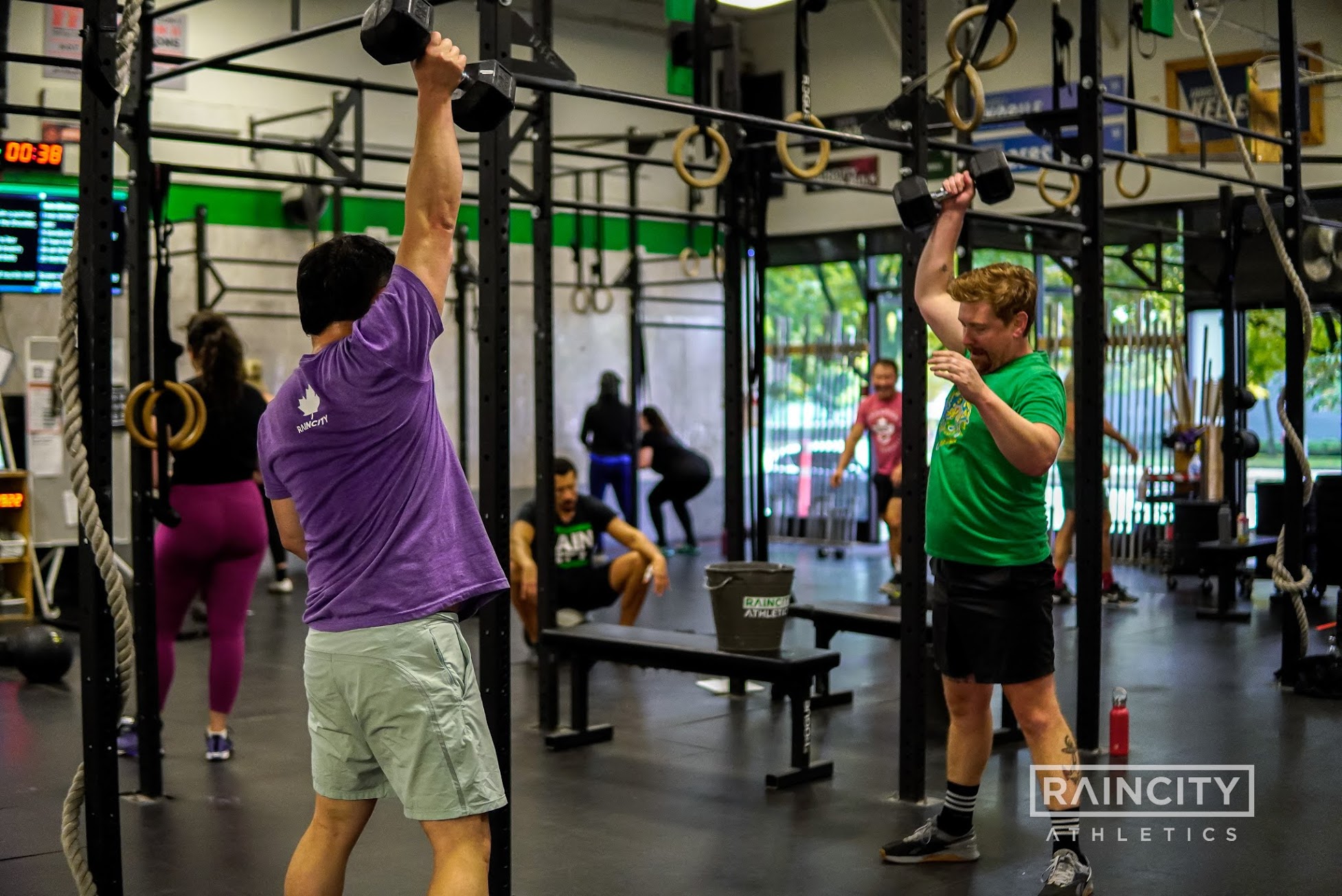 A full class training together on the gym floor with the bay doors open