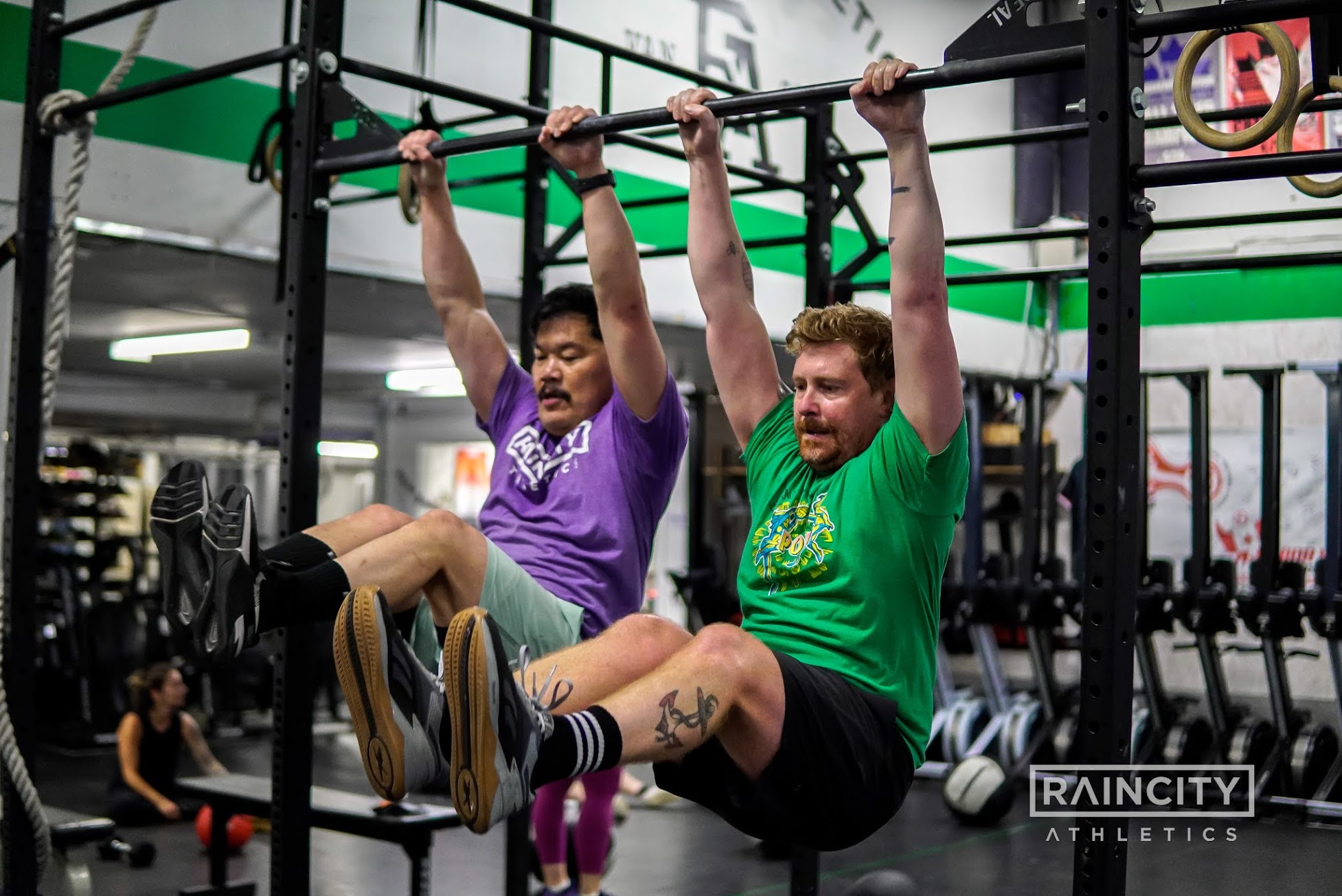 An athlete locking out a dumbbell snatch